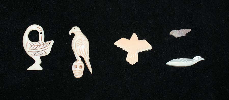 Two carved bone birds and several different sea shell birds. used in bone divination