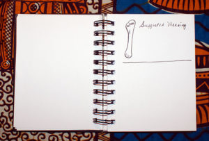 page from little black book with bone drawing