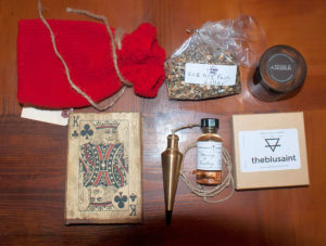 My festival purchases and gifts included a knitted bag for carrying bones from LyannaKnits.com, Herbal Tea from EarthWitchHerbals of Etsy, Body Butters from theblusaint, a blessed and loaded deck of cards, and a loaded plumb pendulum from Professor Porterfield, and an oil from The Skullbone Emporium.