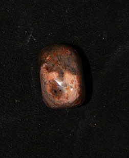 a piece of jasper used in a bone divination set